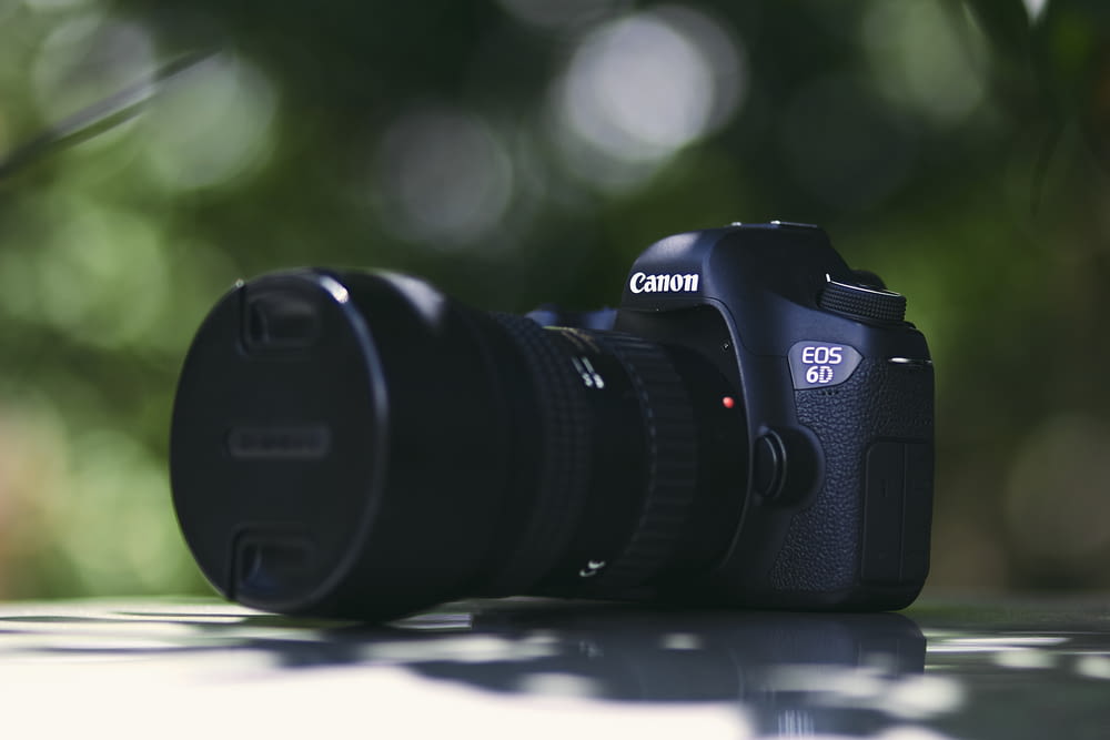 black Canon EOS 6D DSLR camera on white surface