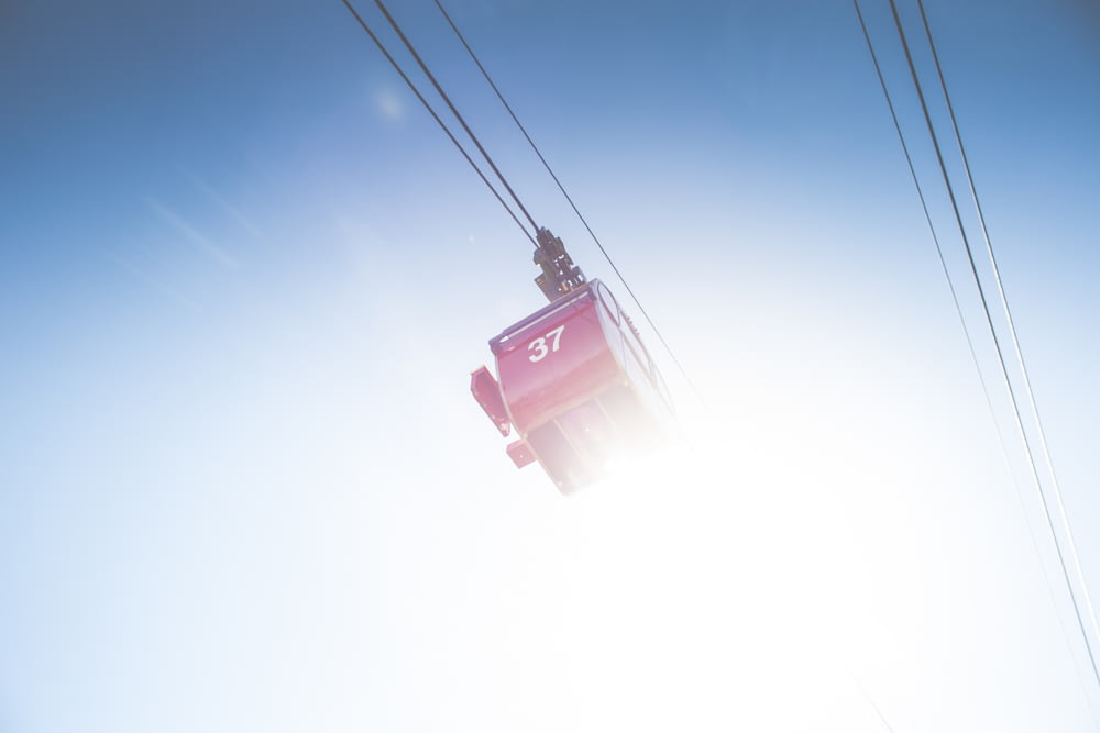 red cable car under clear sky