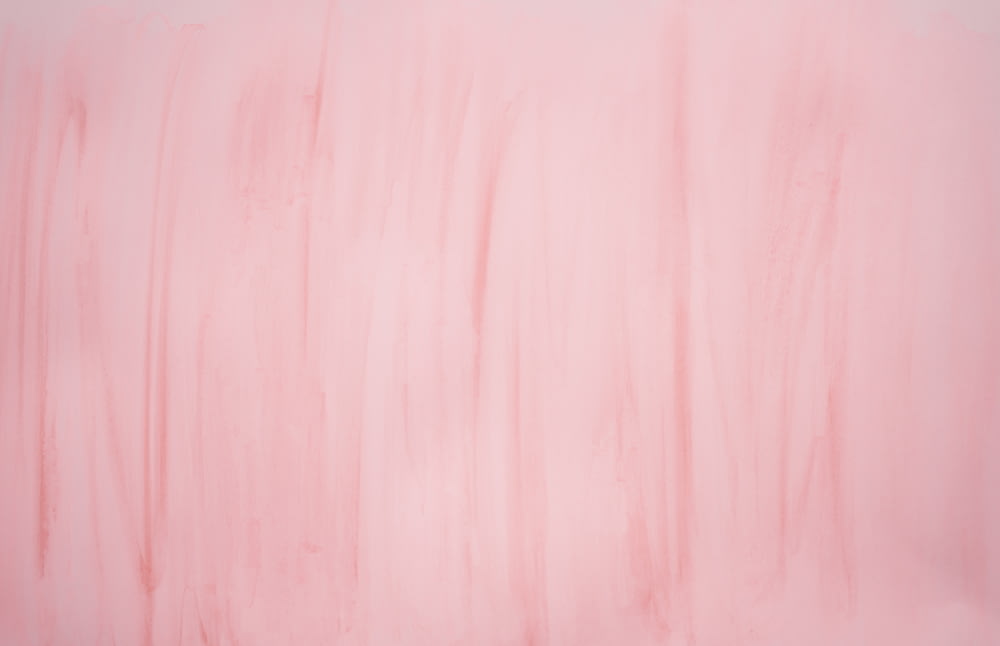 a painting of pink and white lines on a wall