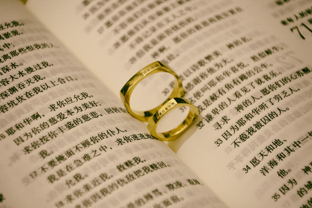 gold-colored rings on book