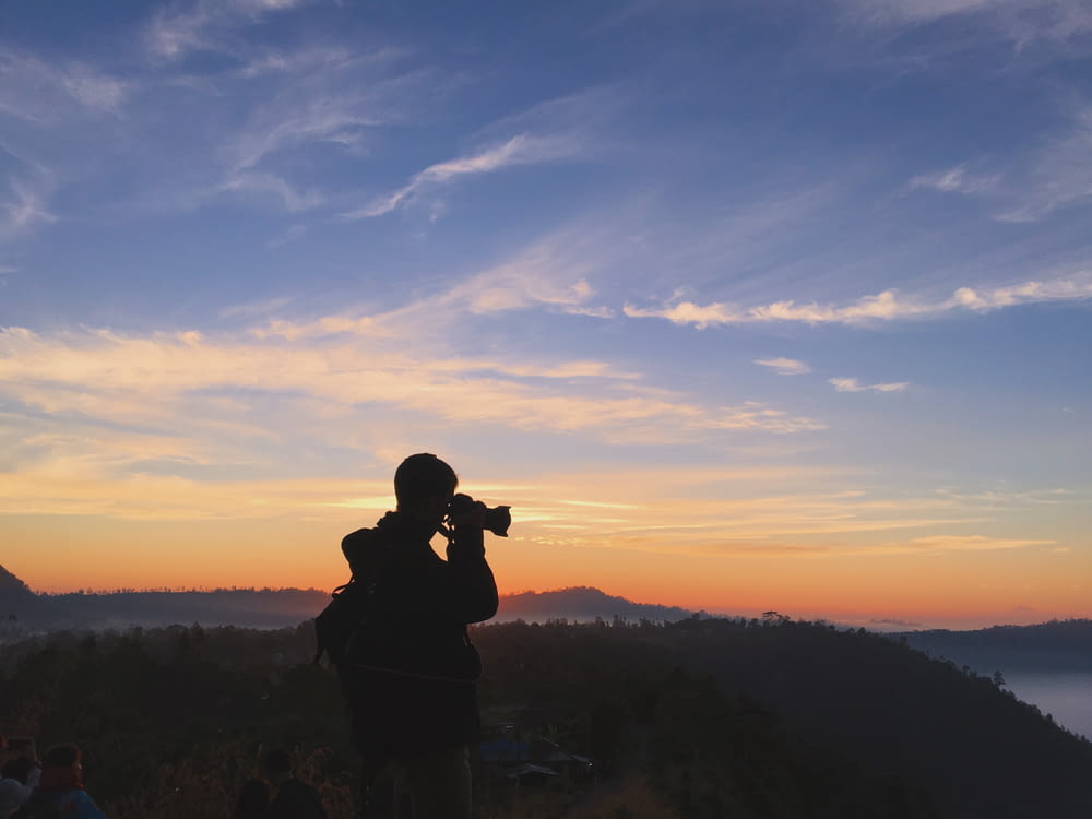 silhouette of person talking photo during sunset