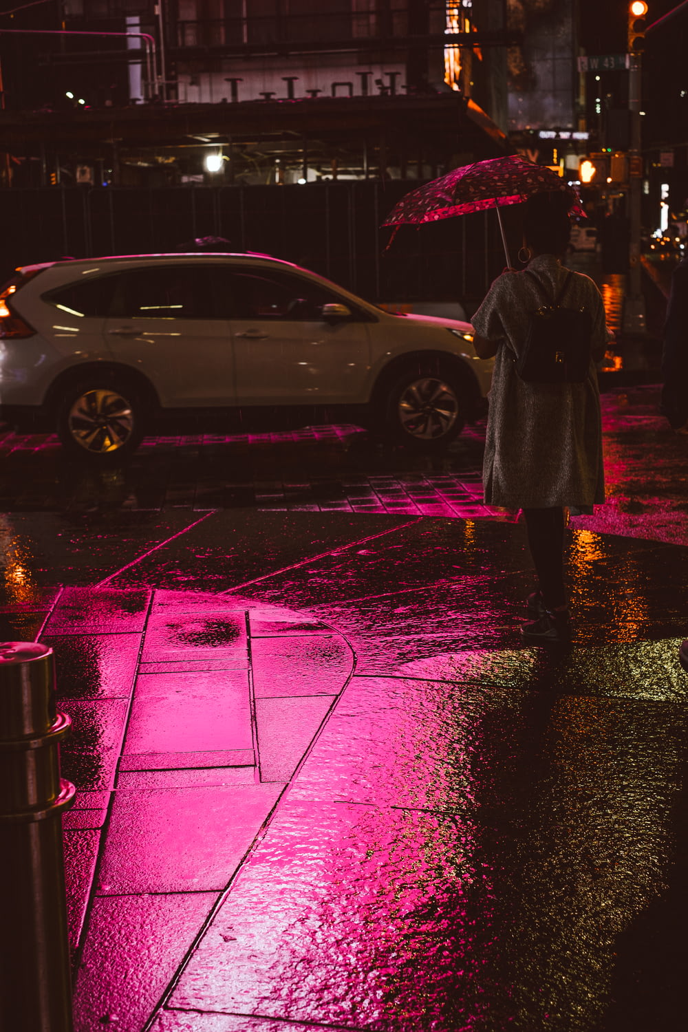 person holding umbrella while walking