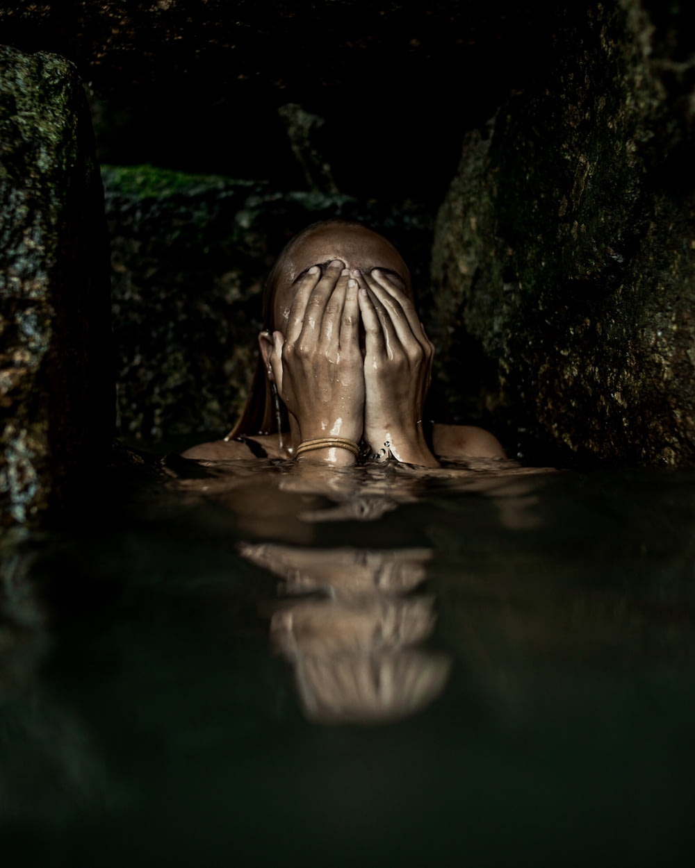 woman on water covering her face with both hands