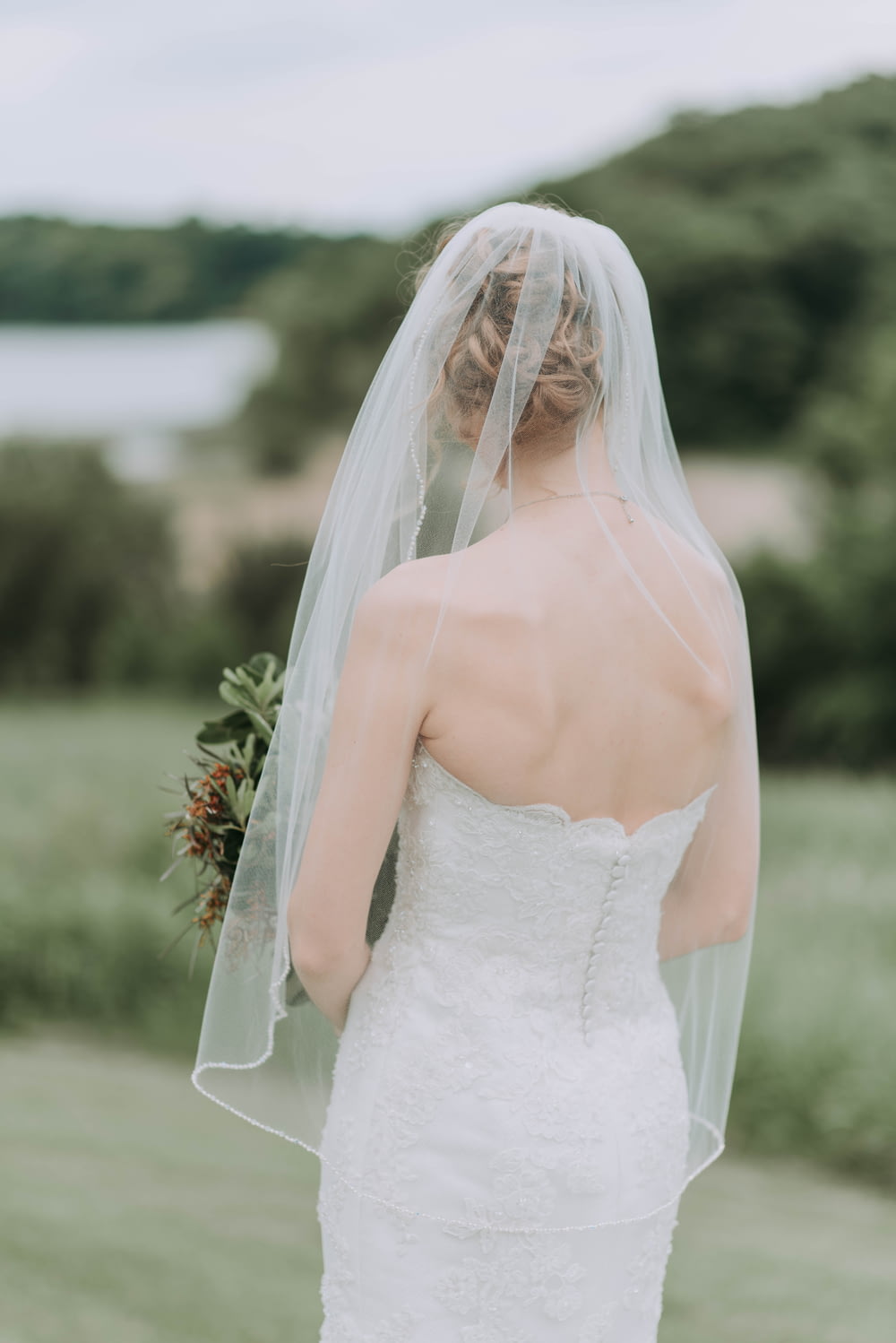 woman wearing white wedding dress holding bouquet