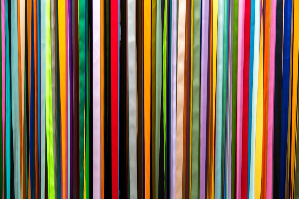 a large group of multicolored sticks in a room