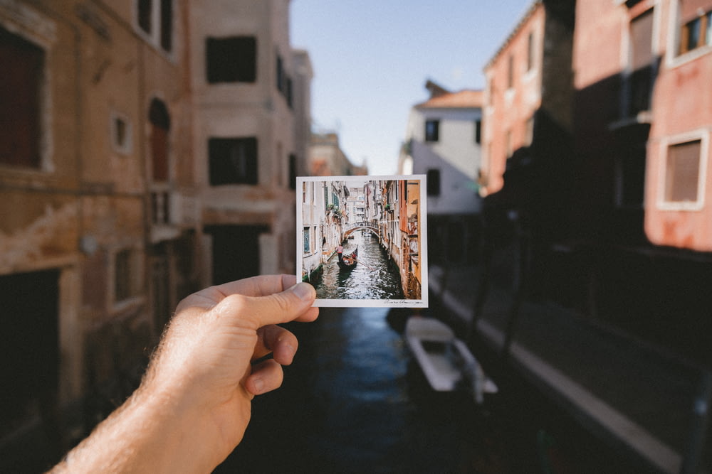 person holding photo of grand canal