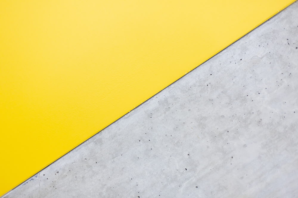 a close up of a yellow and white wall