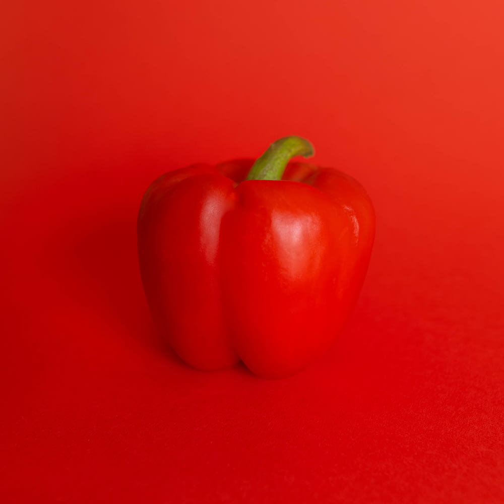 red bell pepper on red surface