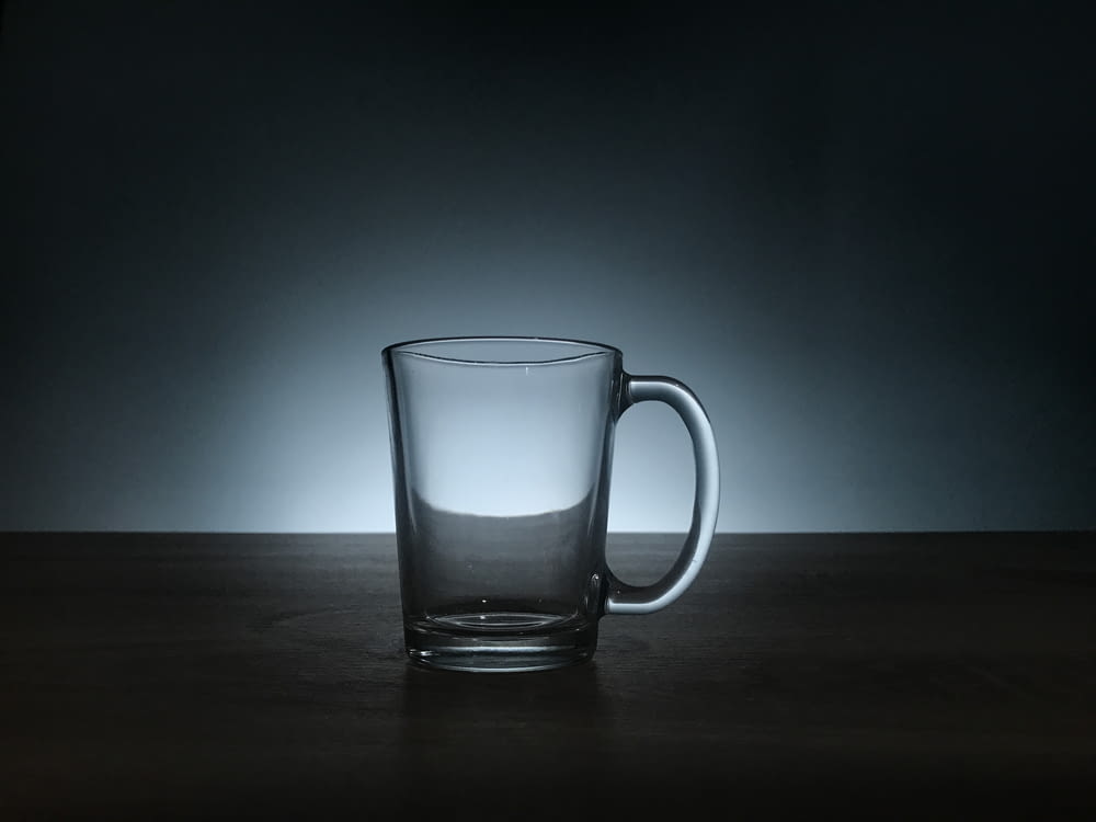 clear glass mug on brown wooden surface