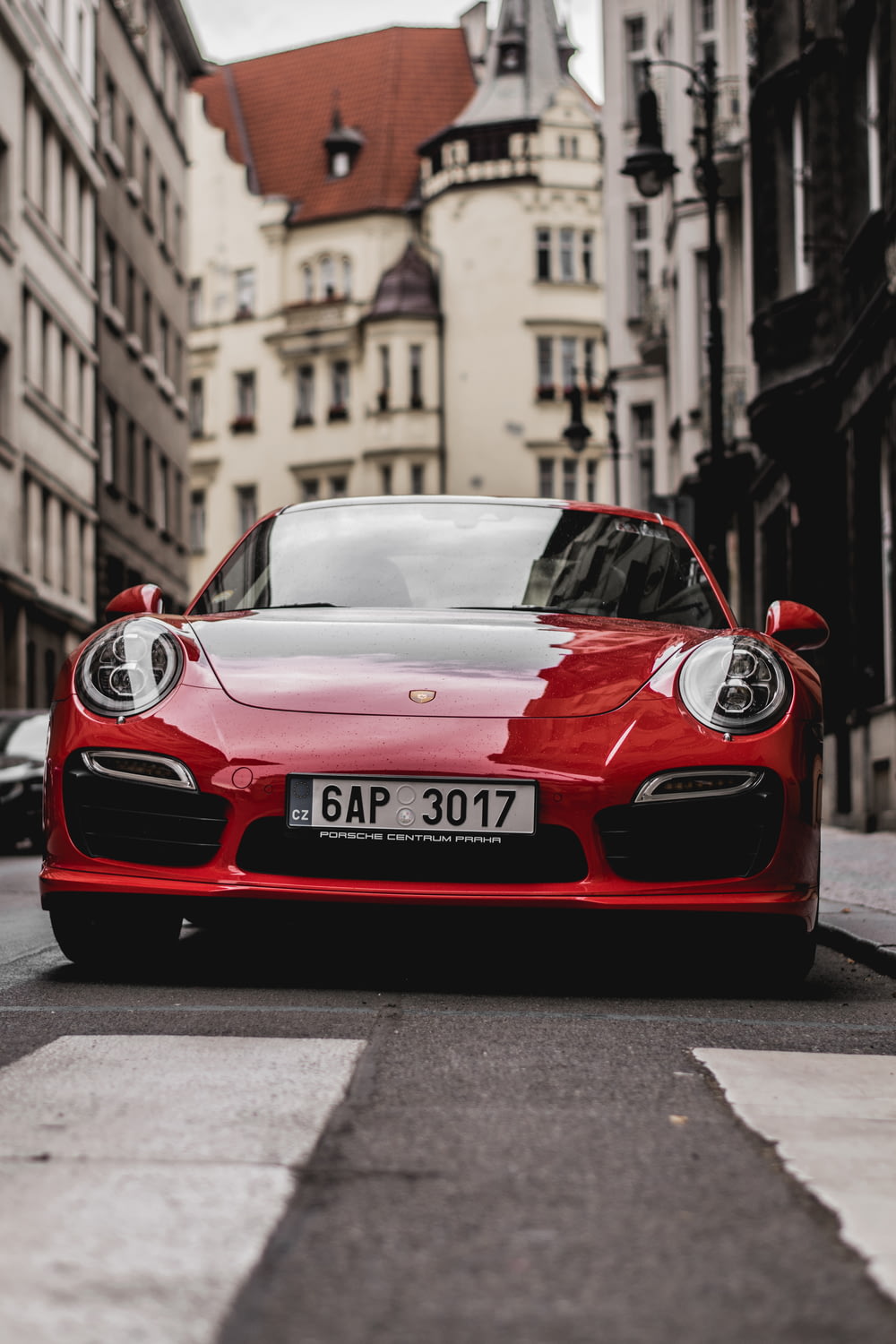 red Porsche vehicle during daytime
