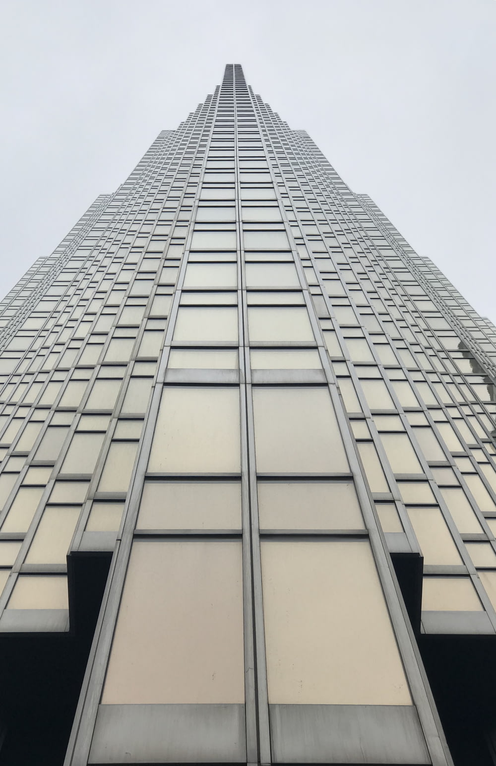low angle photography of grey glass building