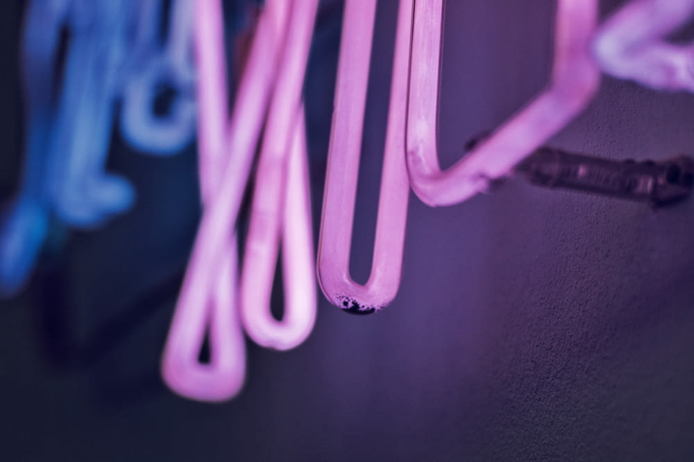 a close up of a wall with neon lights