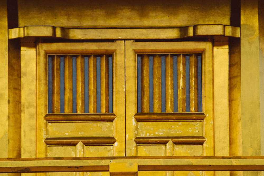 brown wooden door with grilles