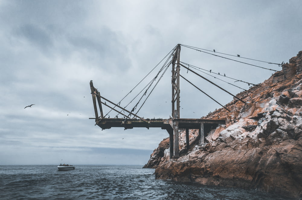 metal bridge near boat during daytime