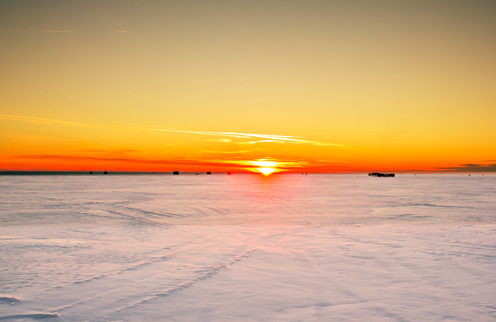 photo of ice field during sunset
