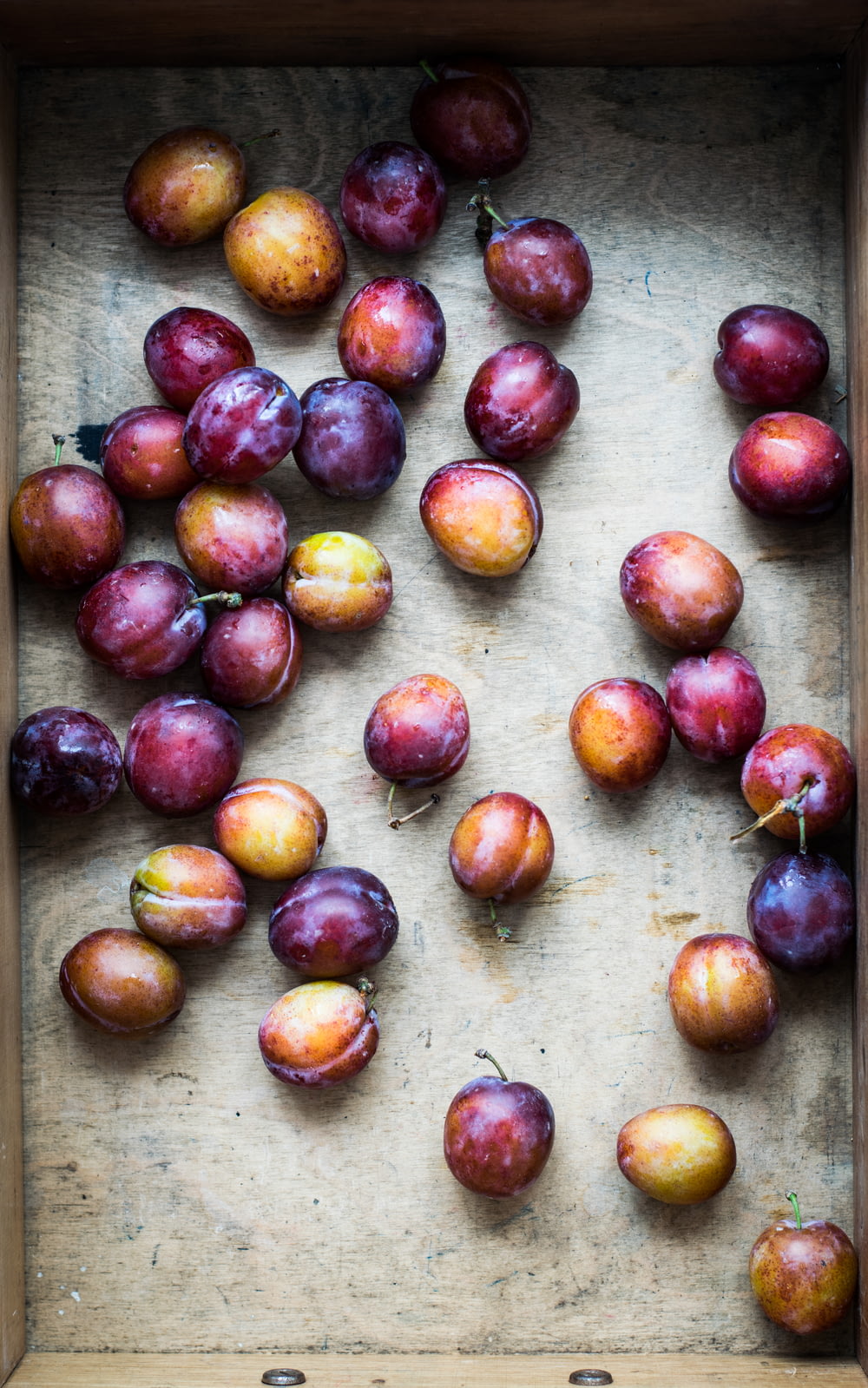 bunch of Spanish plum on brown surface