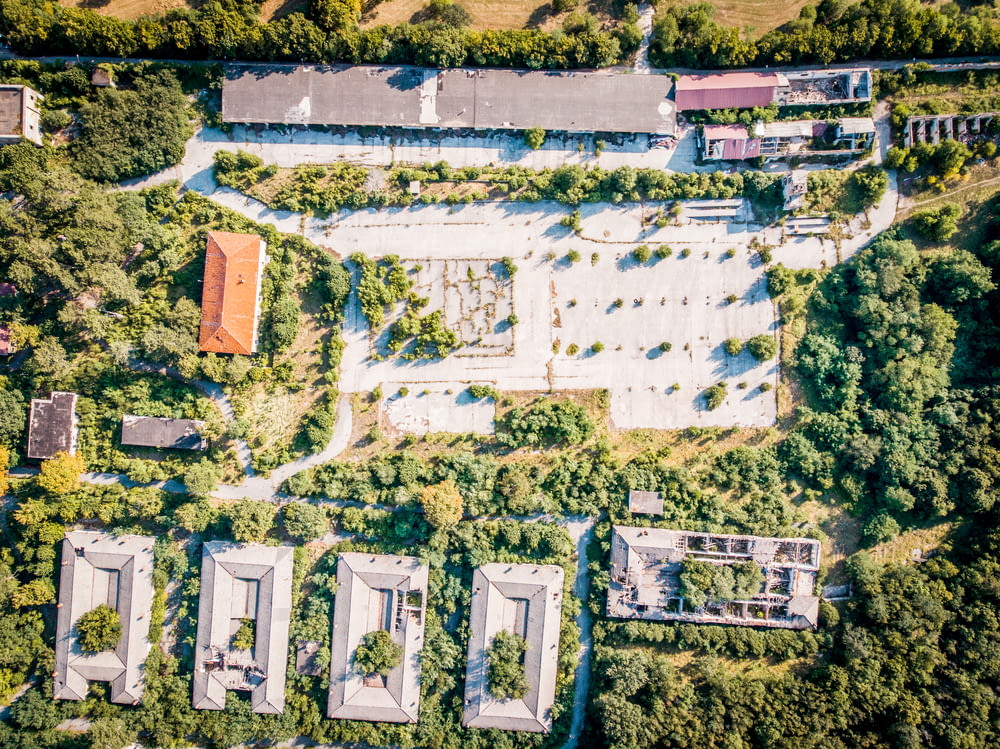 aerial photography of brown gray concrete buildings surrounded by trees