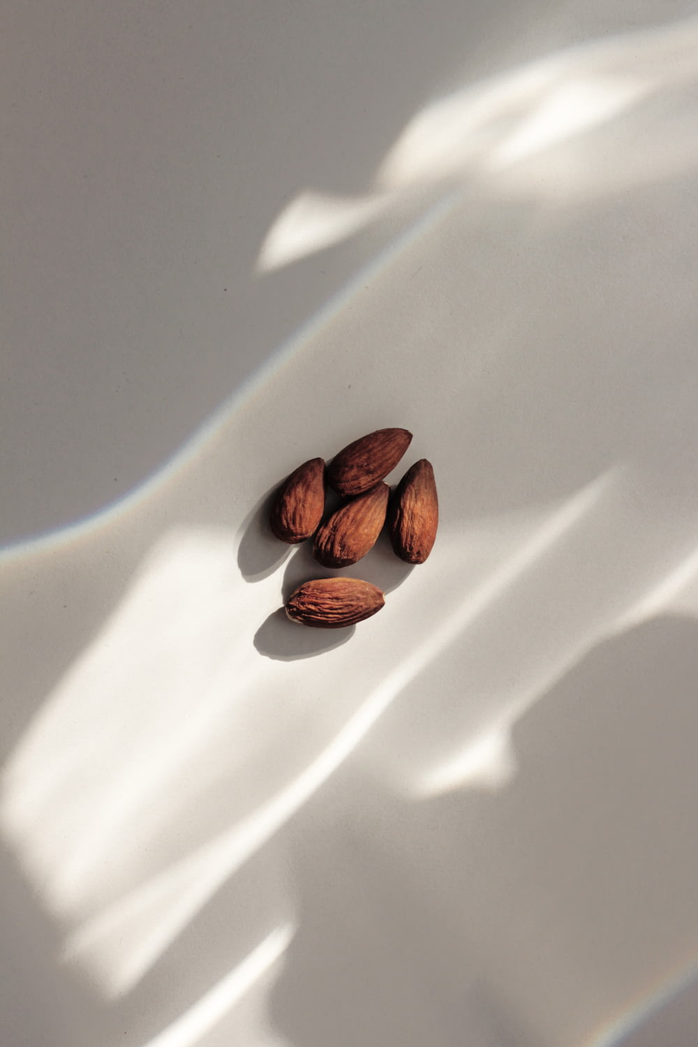 close-up of almond nuts on white surface