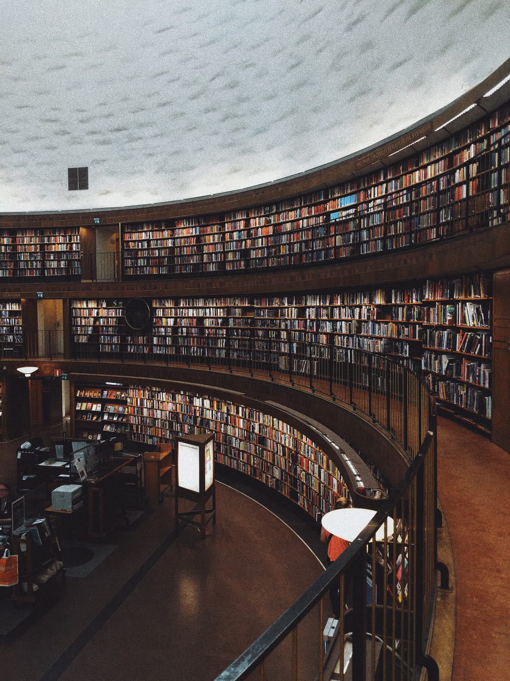 a library filled with lots of books under a cloudy sky