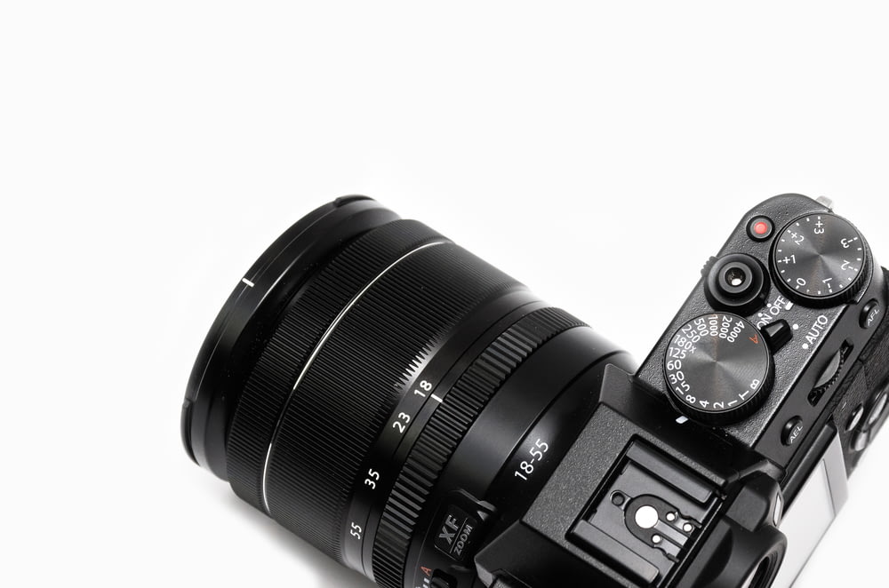 black DSLR camera with lens