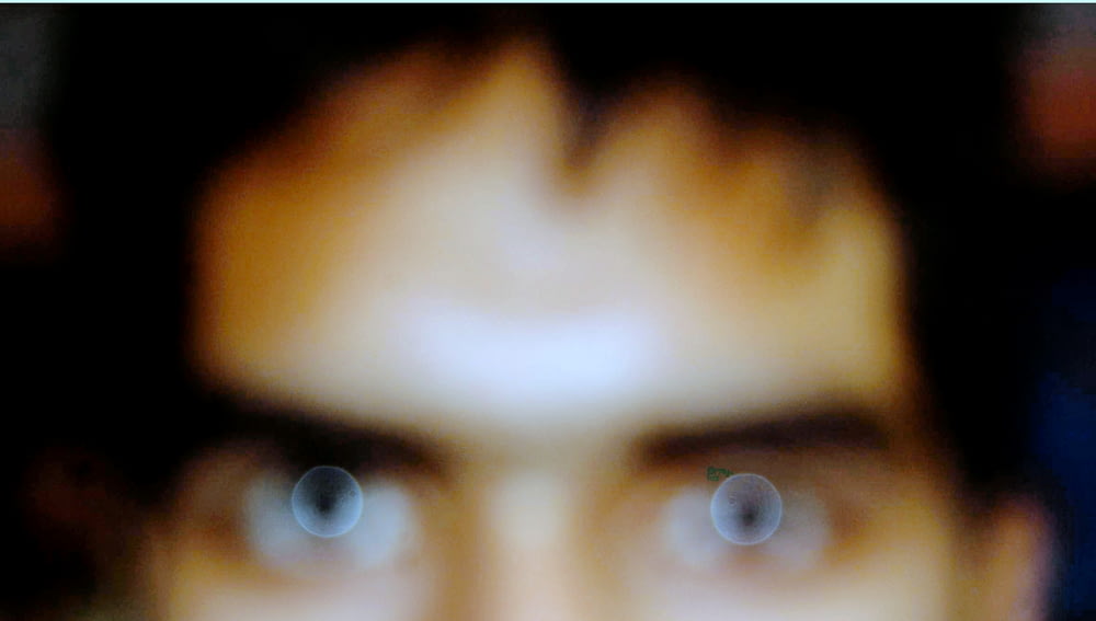 a blurry photo of a man's face with blue eyes