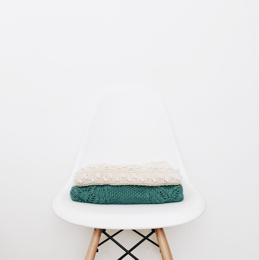 white and teal textile on white stool