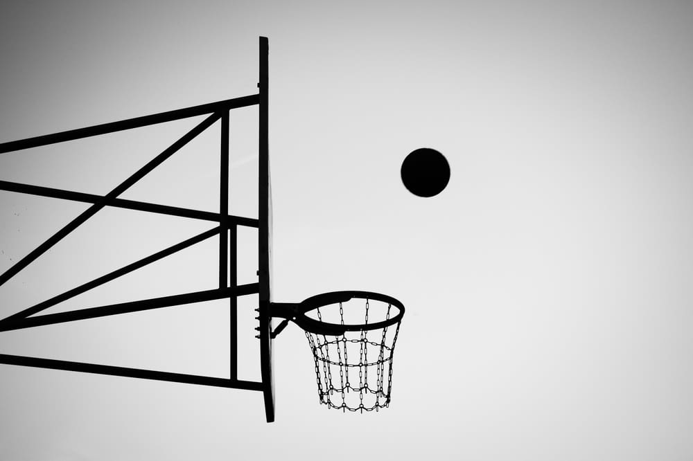 grayscale photo of ball about to shoot