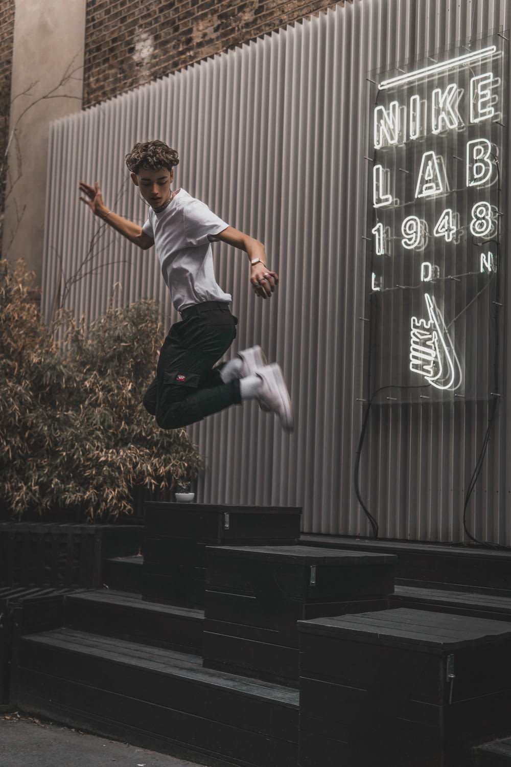man jumping on black black platform
