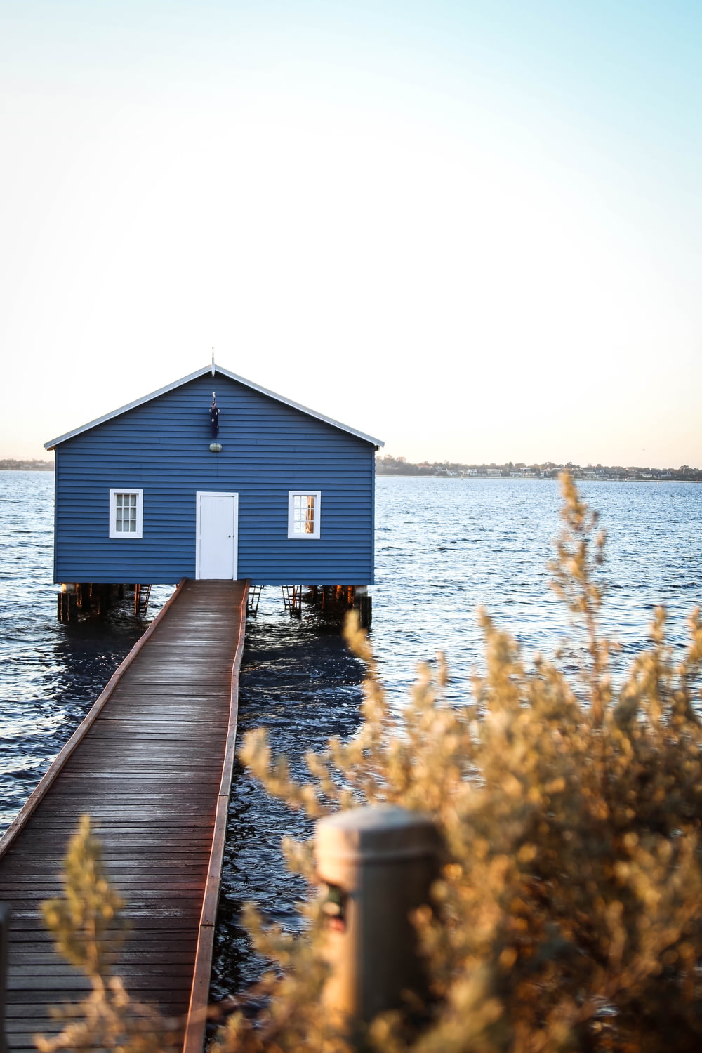 blue house with wooden dock