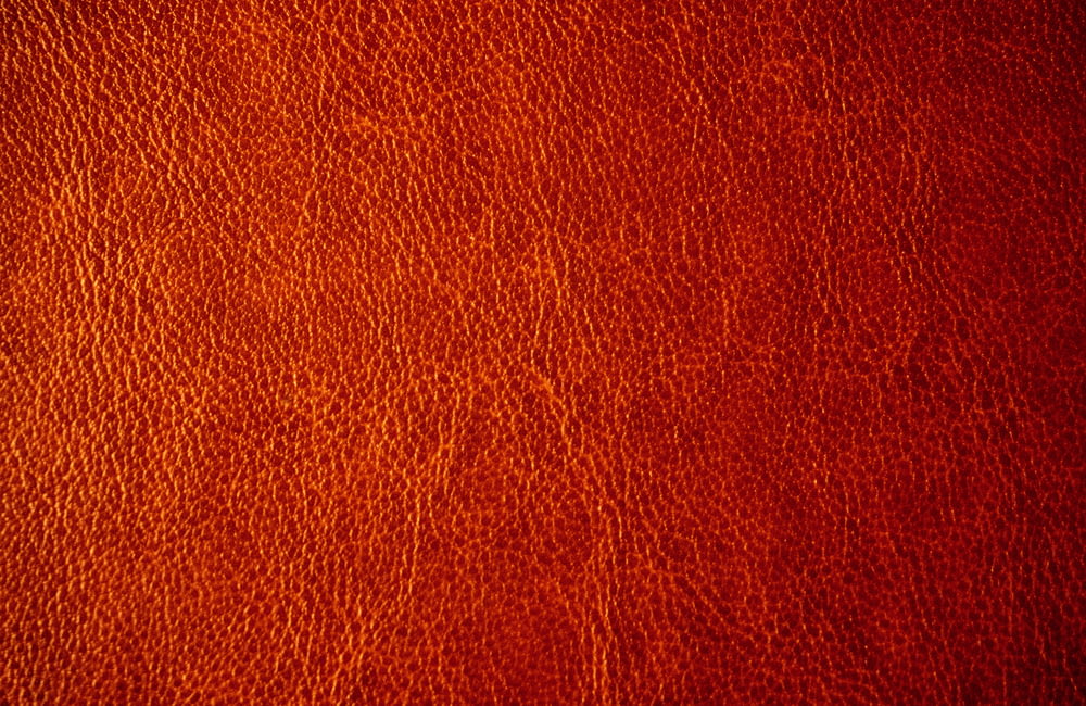 a close up of a red leather texture