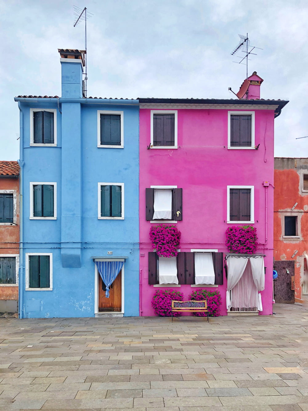 two pink and blue 3-storey houses