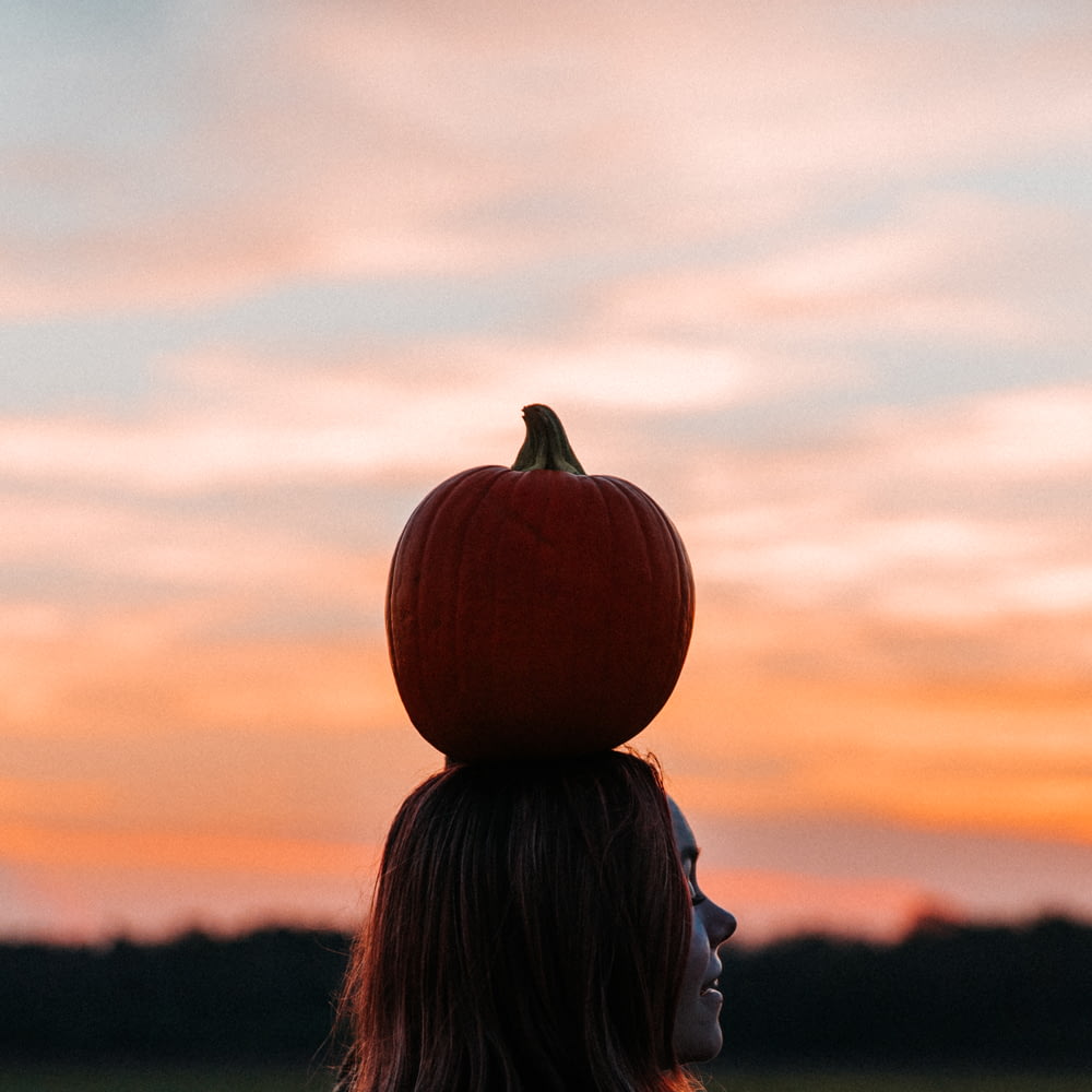 pumpkin on woman head