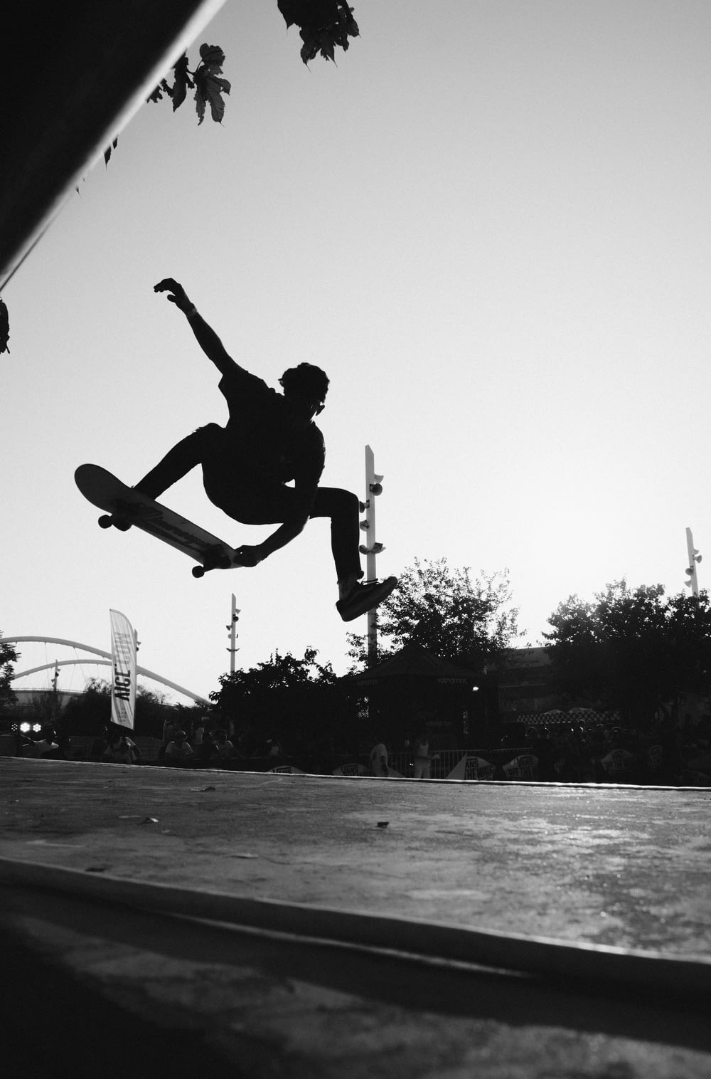 silhouette of man doing skateboard trick