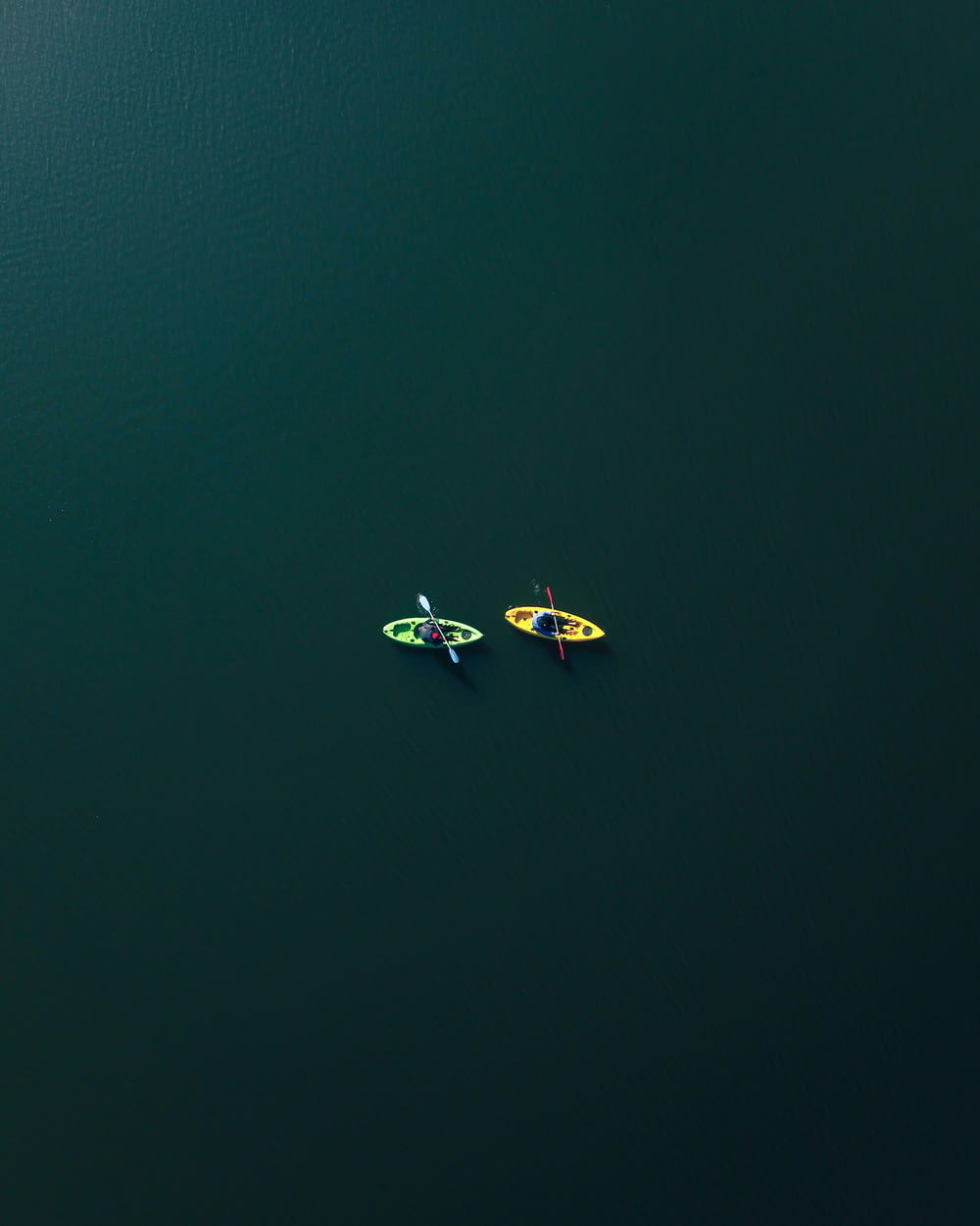 two people riding on two kayaks