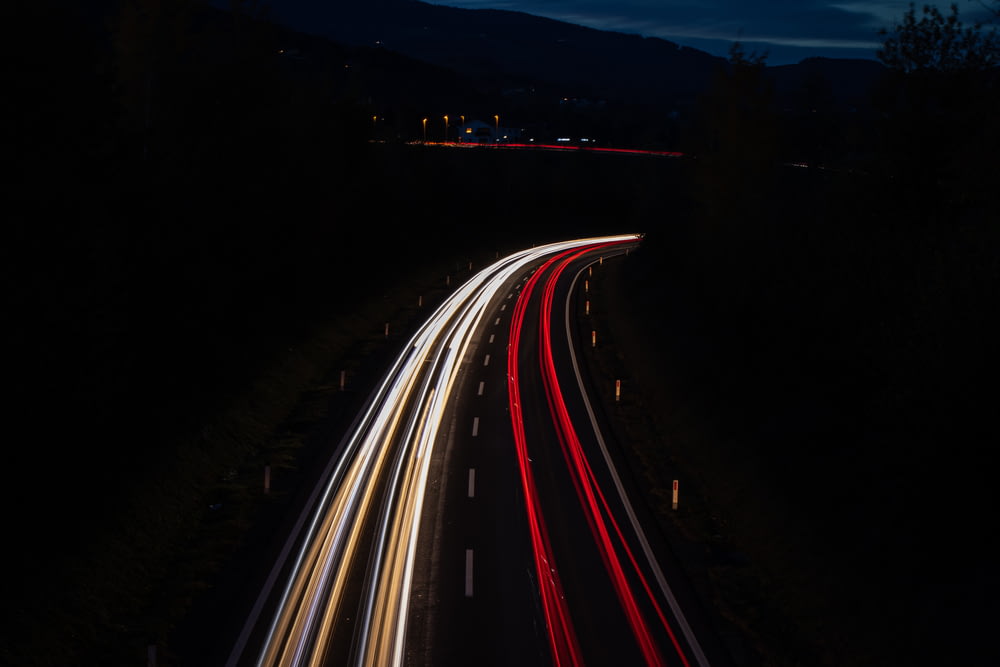 time lapse photo of vehicles on road during night time