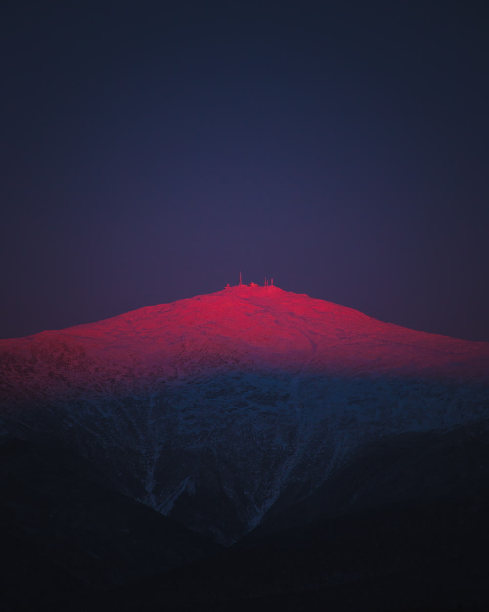 a mountain with a red light on top of it
