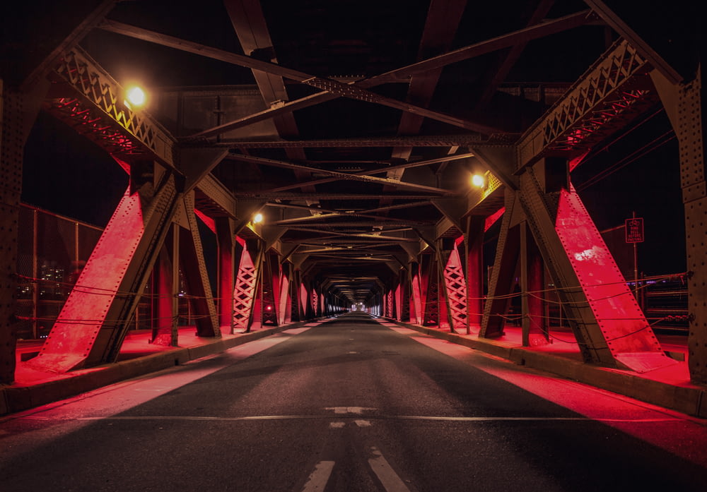 red and black metal bridge during nighttime