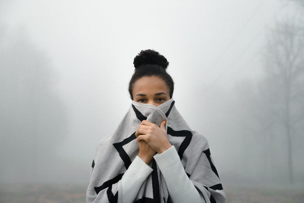 woman covering her face with fog