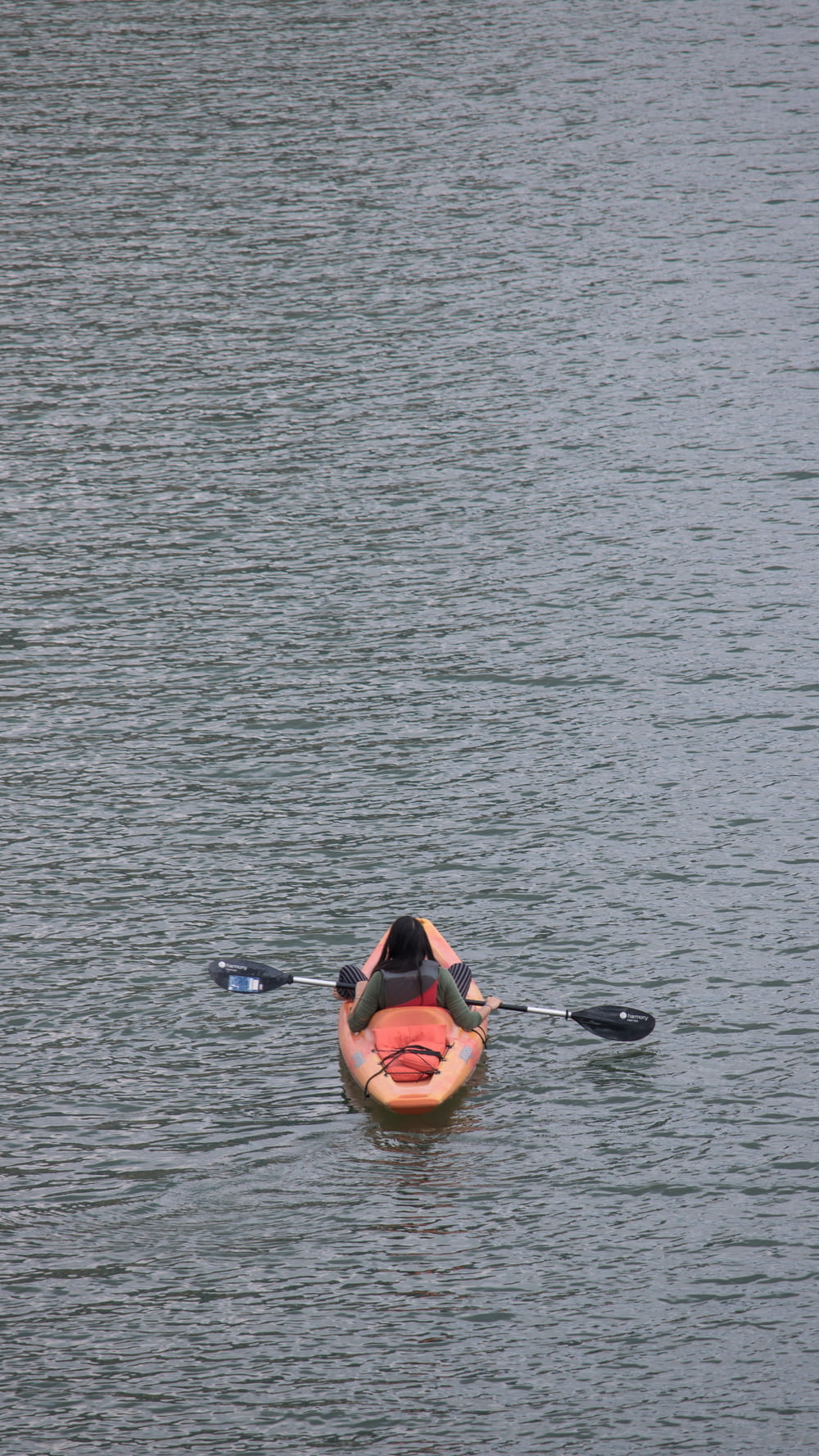 person on kayak on body of water