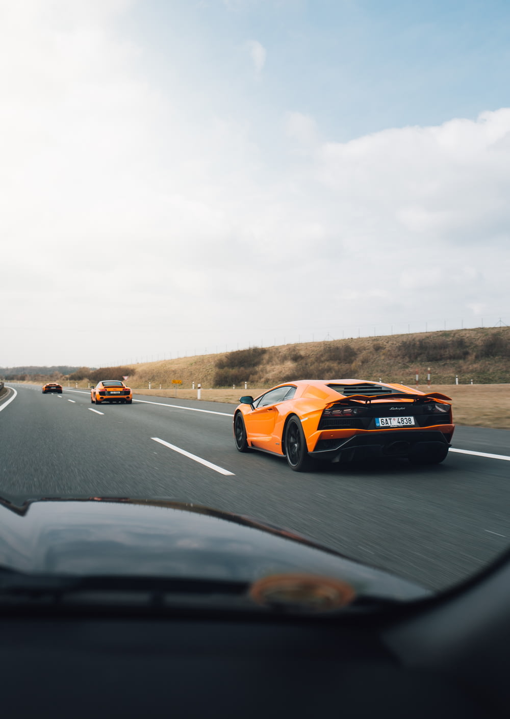 orange Lamborghini on road