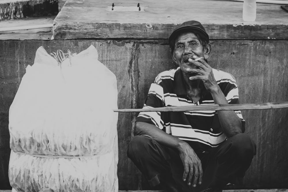 grayscale photo of man about to smoke