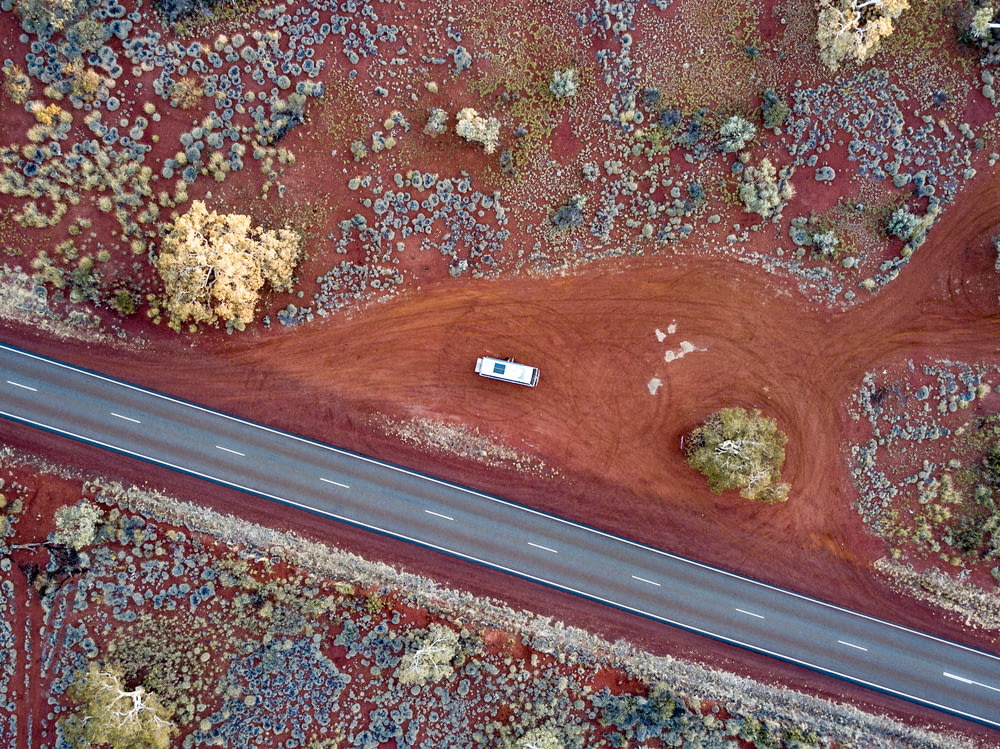 aerial view photography of white vehicle beside road