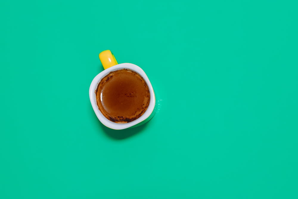 coffee in cup on green surface