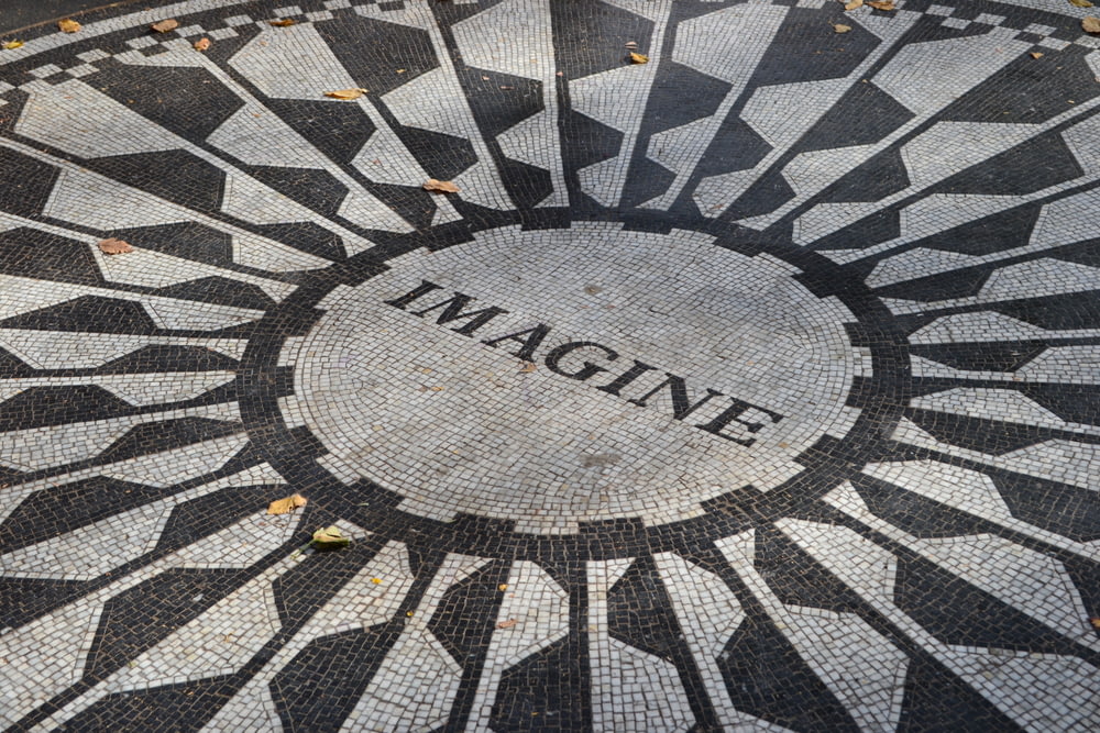 a black and white mosaic with the word imagine on it