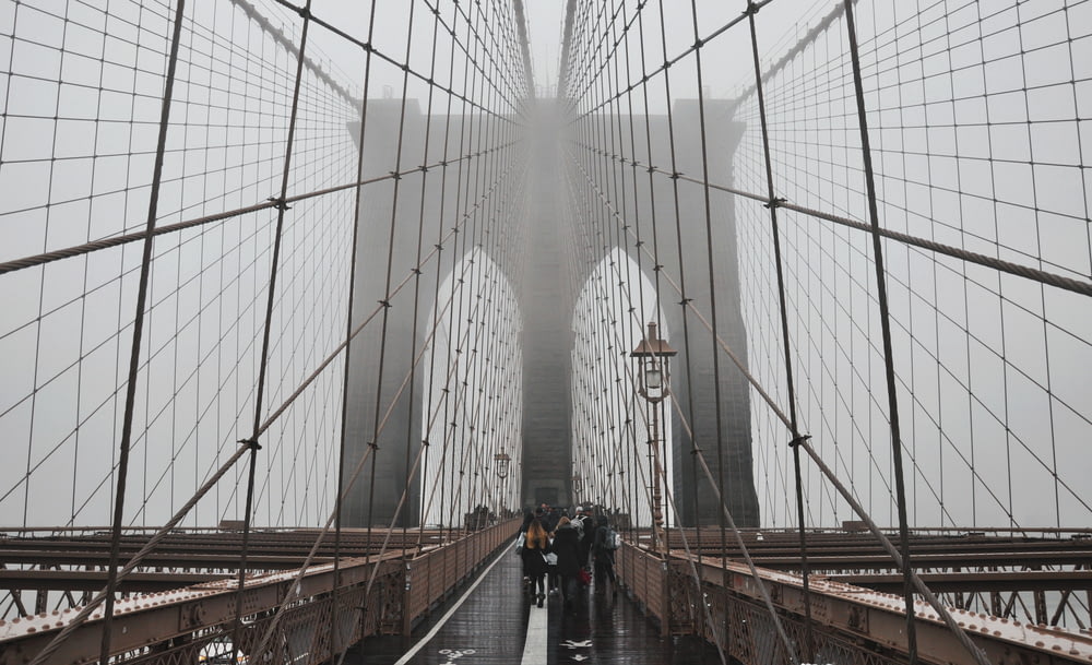 people walking on Brooklyn Bridge