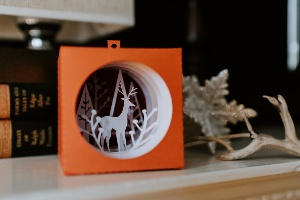 white and orange deer on box Christmas decor