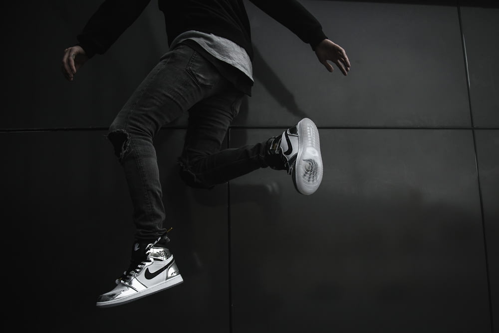 man jumping near wall
