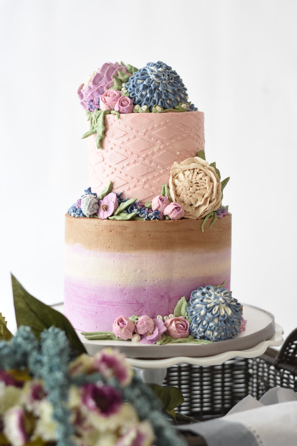 multicolored 2-tier cake on white stand