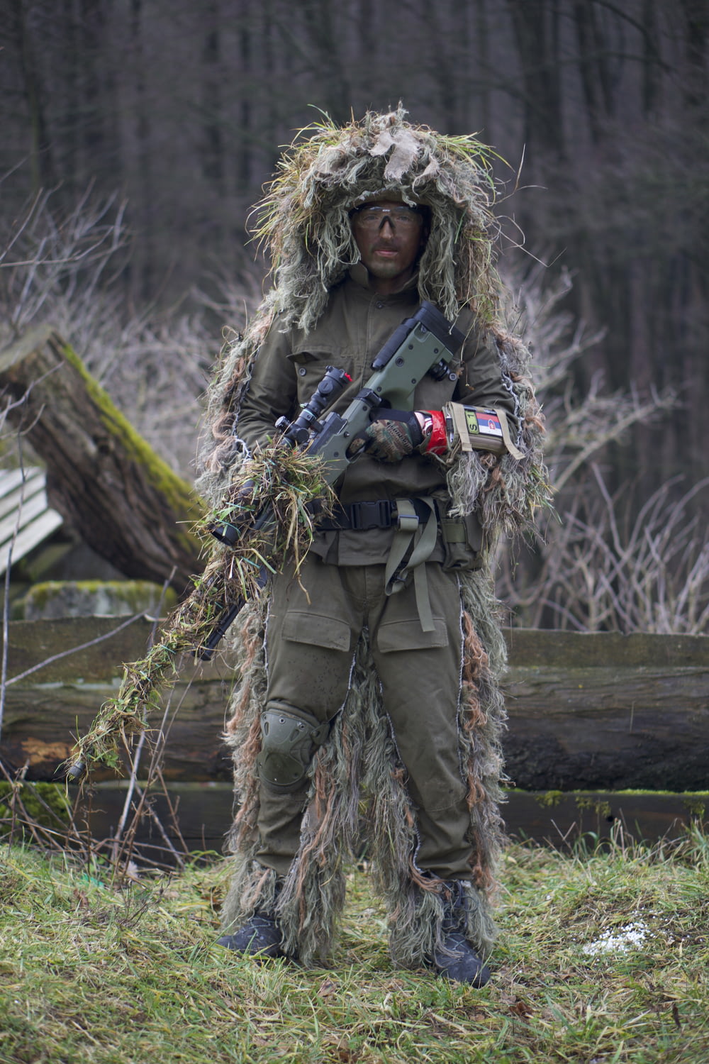 soldier covered with grass holding sniper rifle