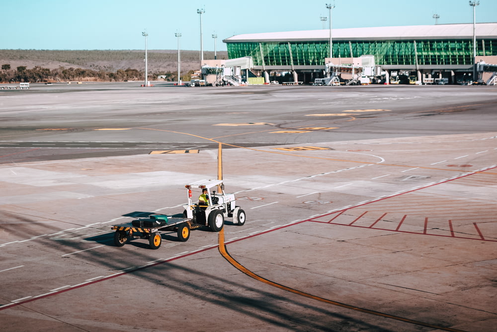 aerial photography of tow trailer in an airport
